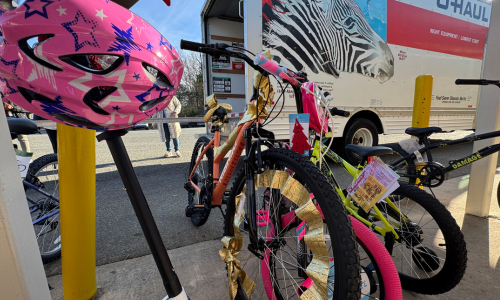  Bikes lined up outside of a U-Haul truck